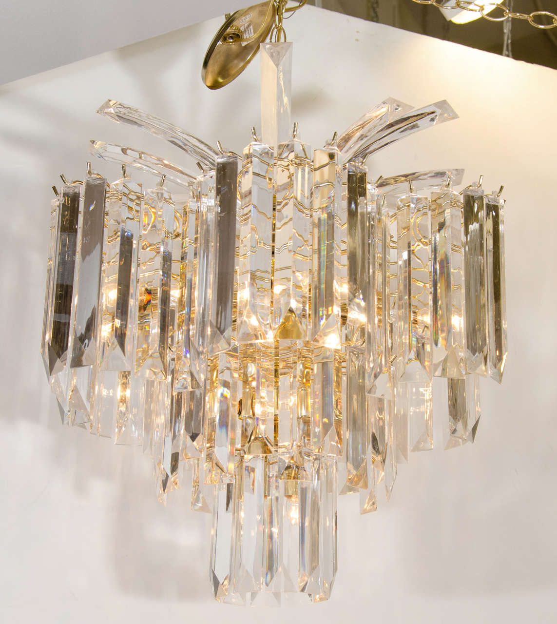 A vintage brass frame chandelier with suspended lucite prisms and a waterfall spray style top.

Good vintage condition with age appropriate wear.