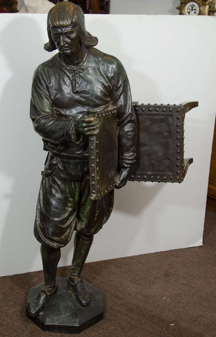 A 19th century Belgian bronze statue of a craftsman holding his finished chair, signed. This was a studio model for the famous suite of 48 sculptures in Sablon Square, Brussels. Each sculpture sits atop a column and represents a craft industry of