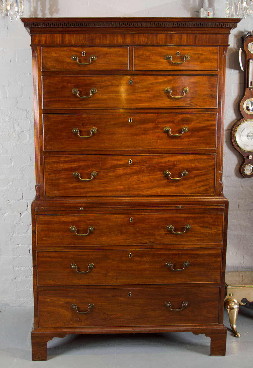 A fine George III period mahogany tall boy with fluted canted corners to the top with two short over three long drawers; the lower section with brushing slide over three long drawers.
Of fabulous warm color and retaining its original swab neck