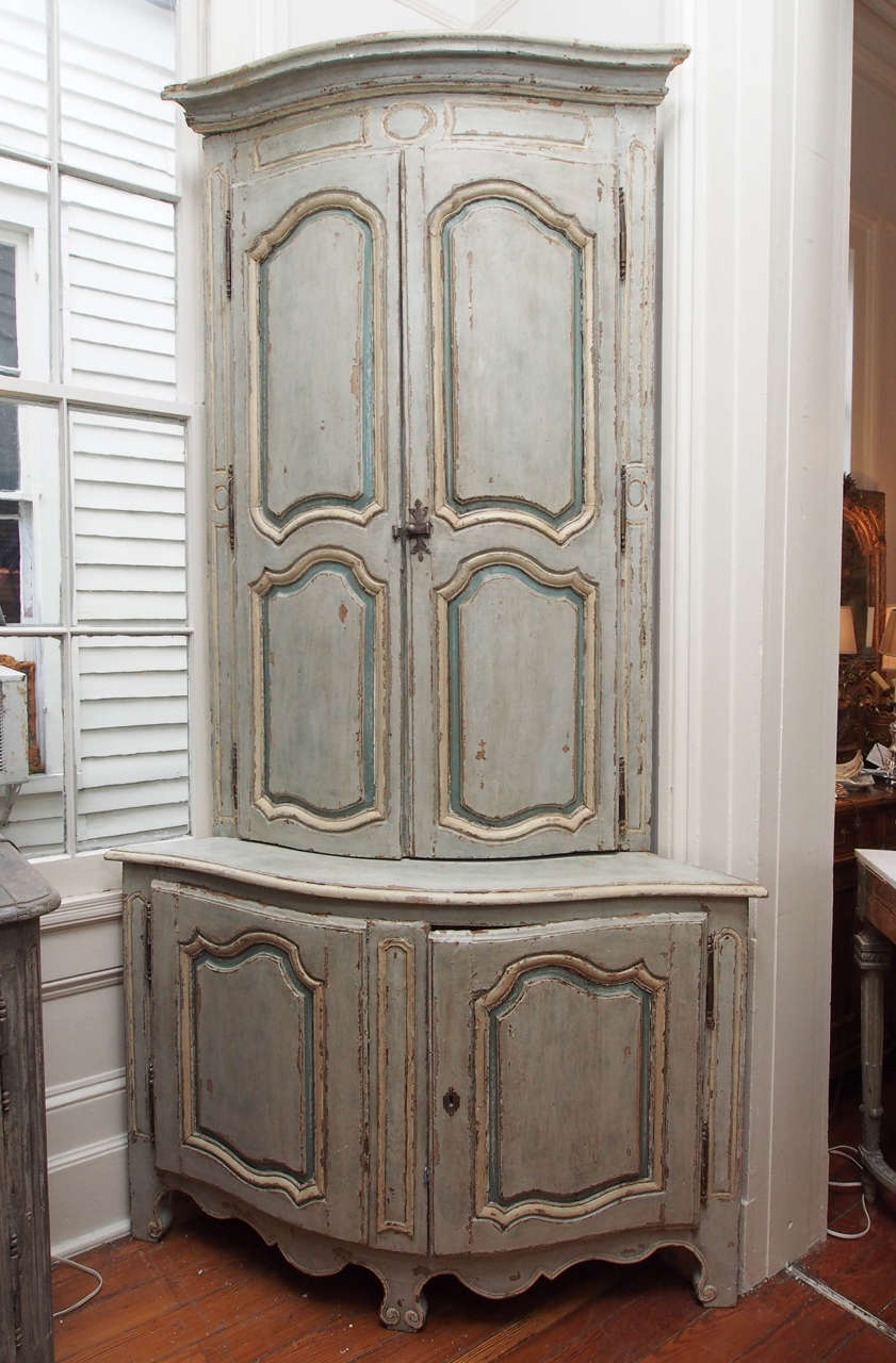 18th century painted corner cabinet. Painted in pale green and cream. 2 shelves in the top part and one shelf in the bottom cabinet.