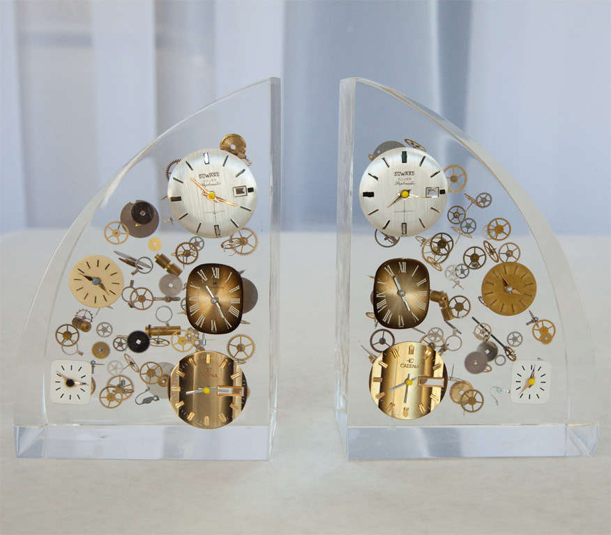 A pair of vintage lucite bookends with encased watch parts.   Parts included are from Duward and Catena watch companies.