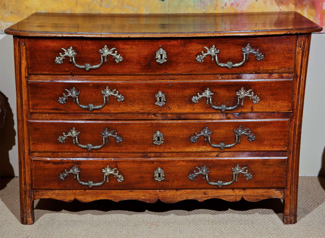 An 18th century French four drawer commode having 19th century hardware.