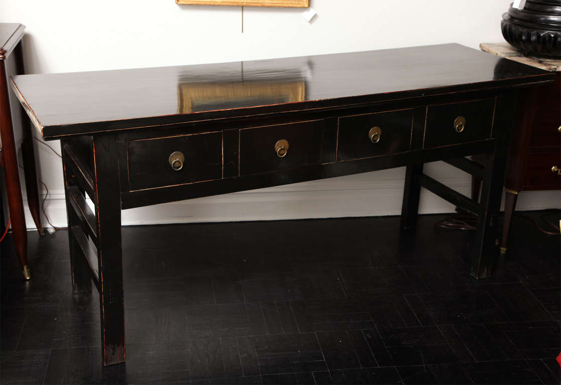 Mid-20th Century ebonized console table, apron containing four drawers with polished ring turned brass handles, four block legs.
