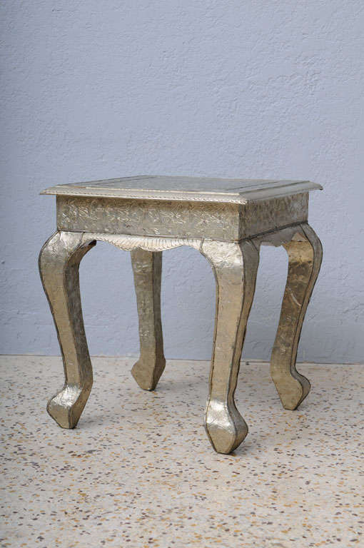 Silvery sheets of embossed nickel alloy are nailed to traditional Western-style wood bases to create these Anglo-Indian side tables. A timeless, casual addition to modern or traditional settings. (And who doesn't like a little shine?)