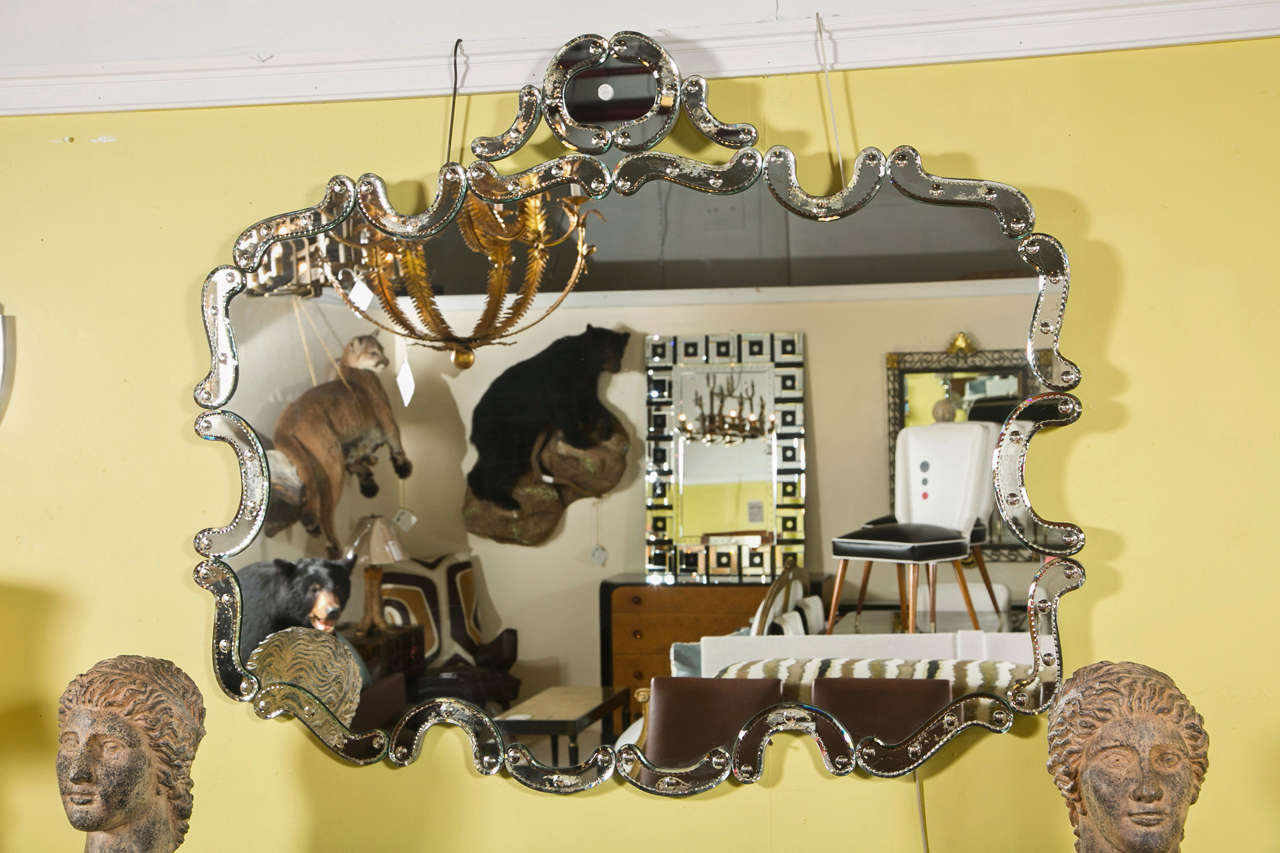 Beautiful Venetian style mirror with etched scroll decorated glass-panel border.