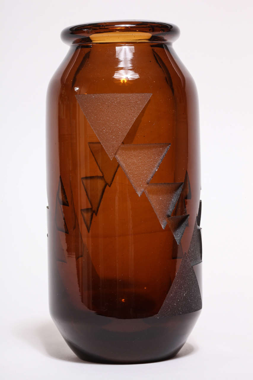 This vase has etched triangles of varying size with repeated decoration around the body.
Signed: artist's monogram

Jean Luce worked as a designer in a cubist-inspired style, rejecting the use of too much design and figurativeness in decoration.