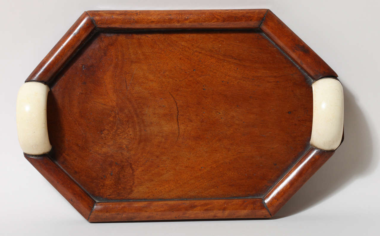Octagonal mahogany tray with beautiful patina and large semi-circular ivory handles.