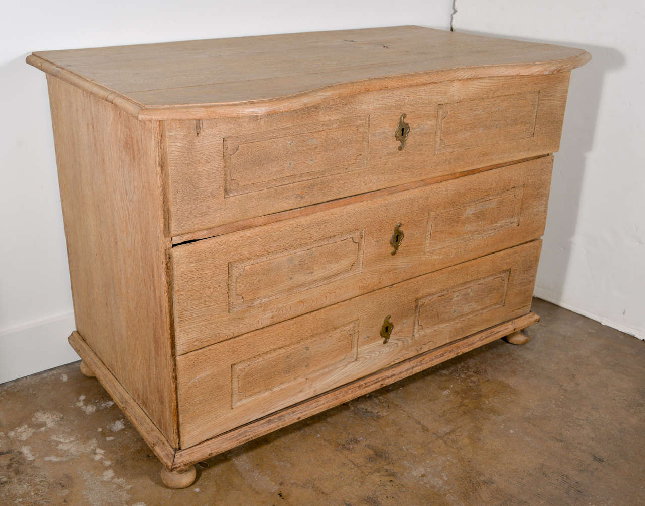 Two-drawer Belgian commode with three drawers. Oak has been bleached. Each drawer has two carved panels with beautiful detail.