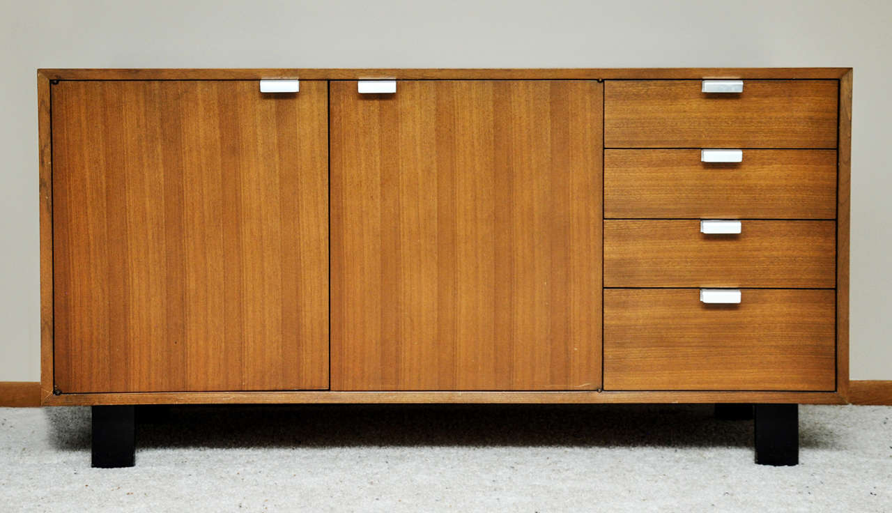 A circa 1950s George Nelson Designed Credenza for Herman Miller.  Walnut wood, ebonized wood legs and nickel drawer pulls.