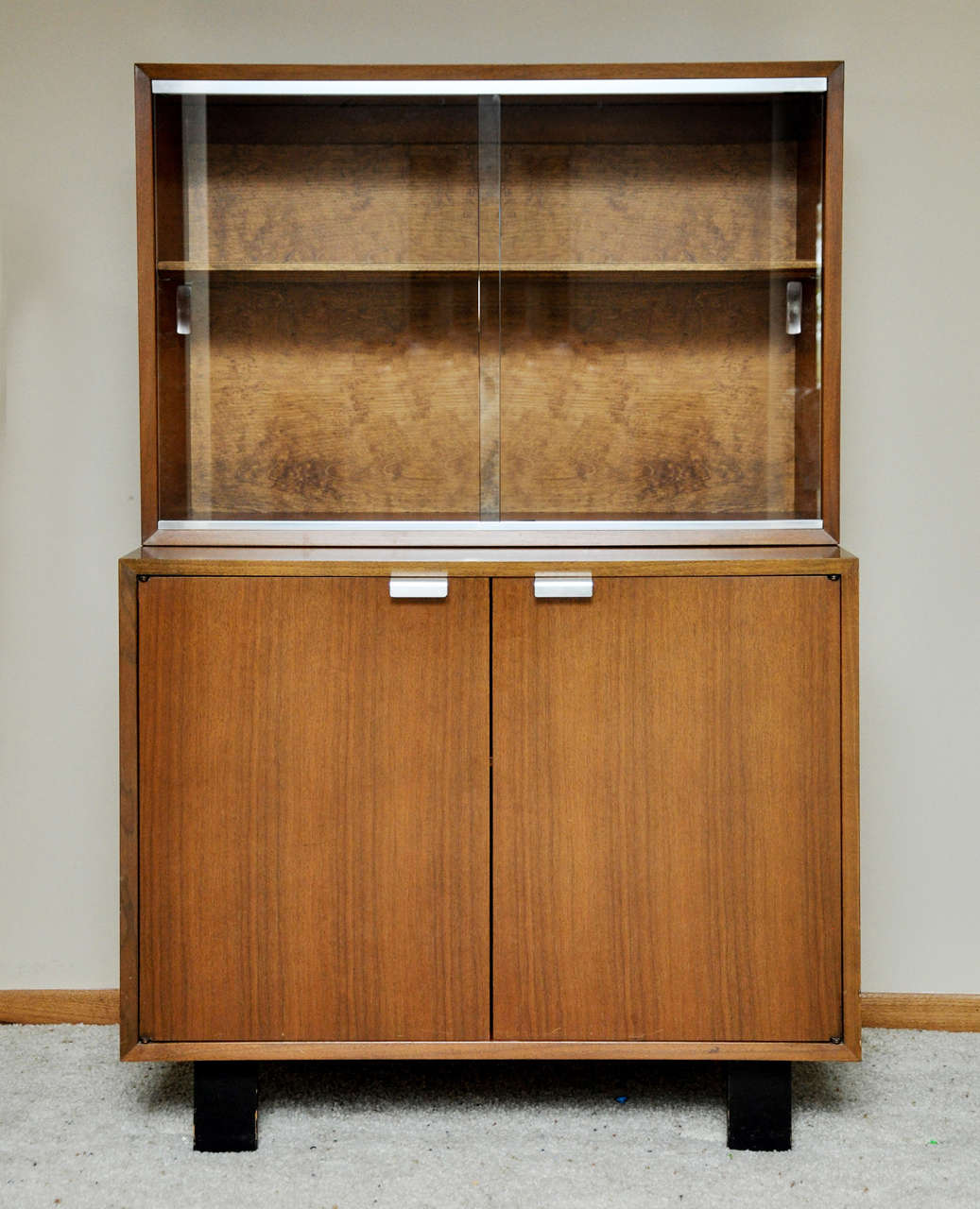 Circa the 1950s - a two piece small credenza with a bookcase top.  Designed by George Nelson for Herman Miller.   Part of their Primavera Collection.