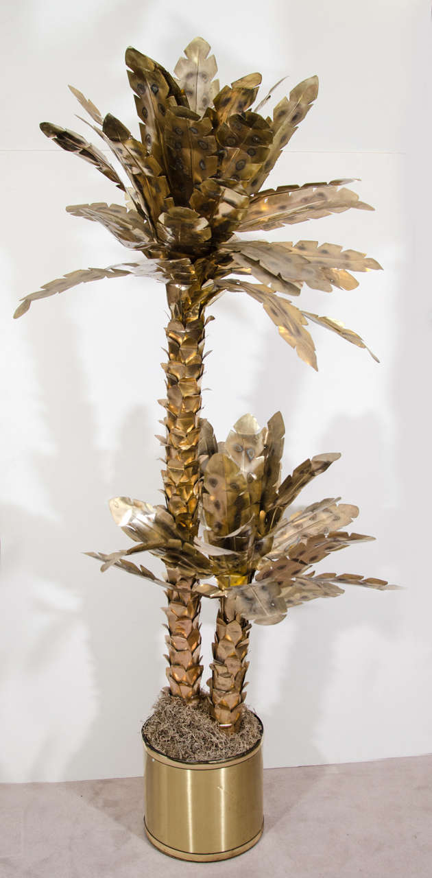 A large vintage brass sculpture of two standing palm trees set in a drum base. The piece is similar to works produced by Curtis Jere.

Reduced from: $2,200