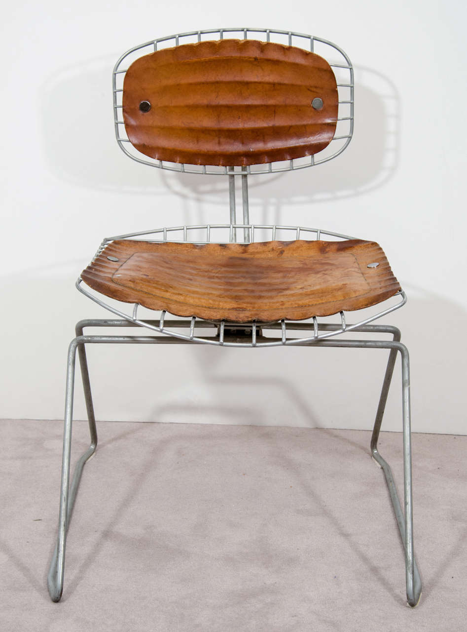 A set of four vintage library chairs in metal with distressed leather seats and backs. They were originally designed for the Pompidou Center in Paris by Michel Cadestin and Georges Laurent.

Reduced from $11,000
