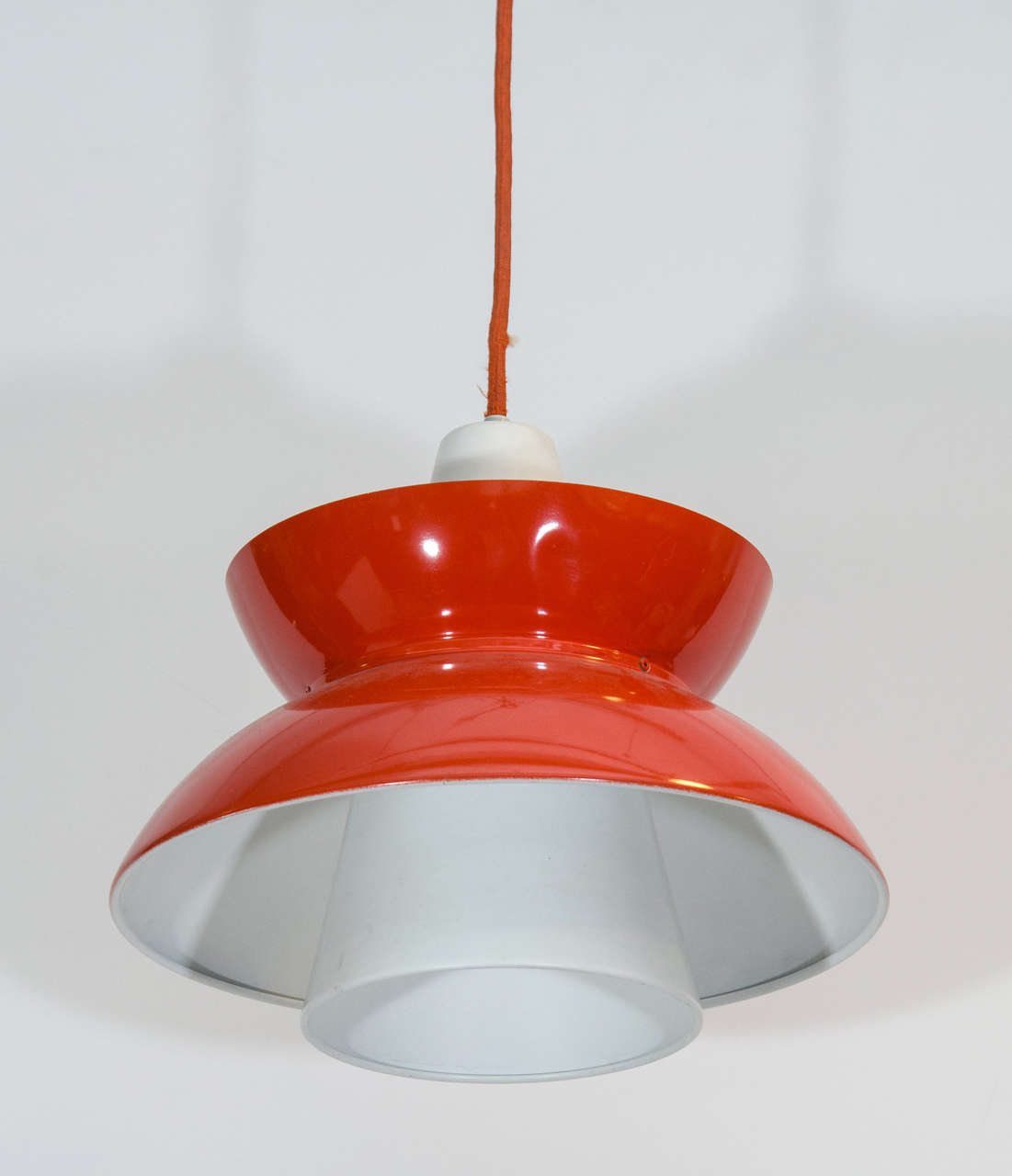A vintage pendant light by designer Jorn Utzon in red with a white interior. Wiring and sockets to US standard. Very good condition, consistent with age and use. 