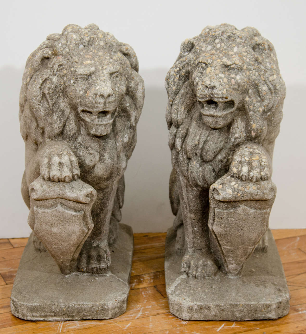 A pair of decorative early 20th Century cement and stone lion sculptures with shields.

Reduced from: $2,450