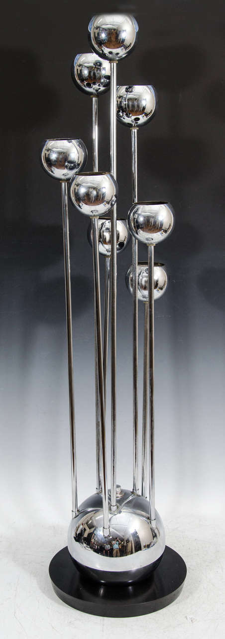 A vintage pair of chrome table lamps on black pedestal base. Each has eight ball-shade lights.