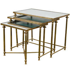 A Mid Century Set of Three Mirror and Brass Nesting Tables A Mid Century Set of Three Mirror and Brass Nesting Tables