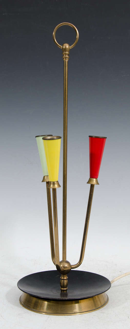 A vintage brass and enamel table or desk lamp attributed to Stilnovo. The piece features three brightly colored sockets. 

Euro. Wiring and sockets.