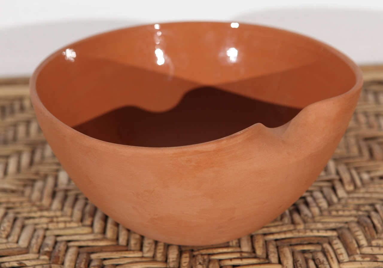 Hand thrown and finished terra cotta bowl by Elsa Peretti for Tiffany.  Made in Italy.  Thumb fold at one edge.
Glazed interior surface and bisque exterior surface.