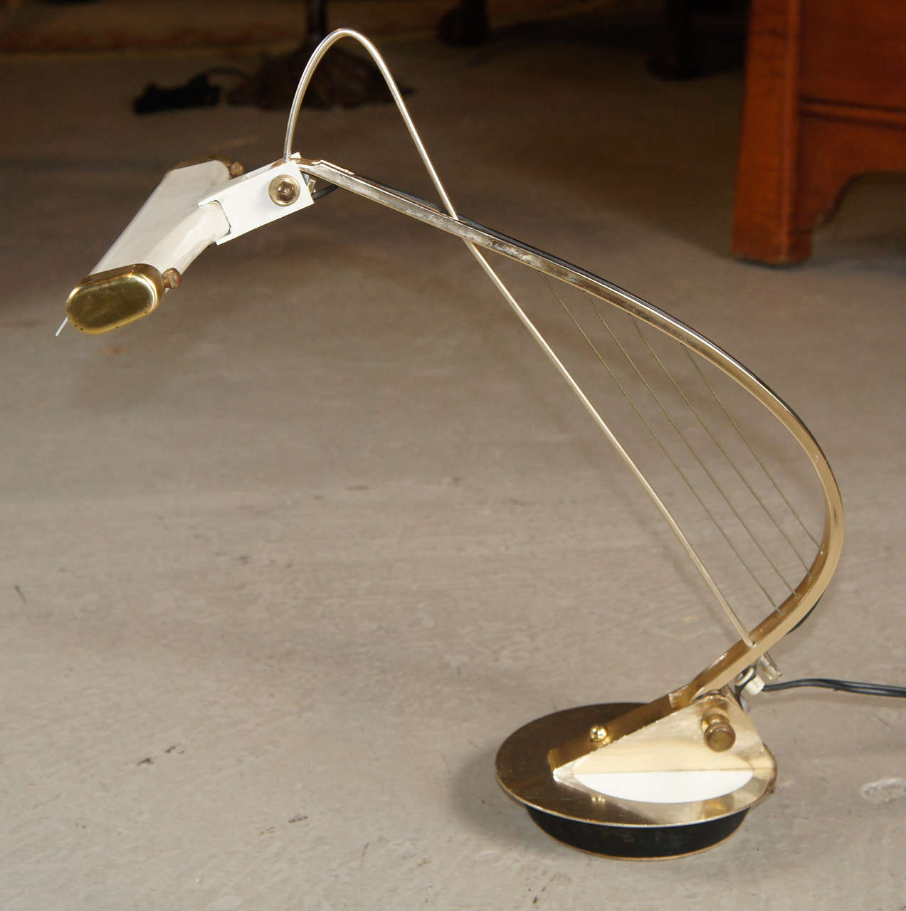 A rare and unusual brass desk lamp made by Cannon in the 1970s. Fully adjustable with harp string detail.