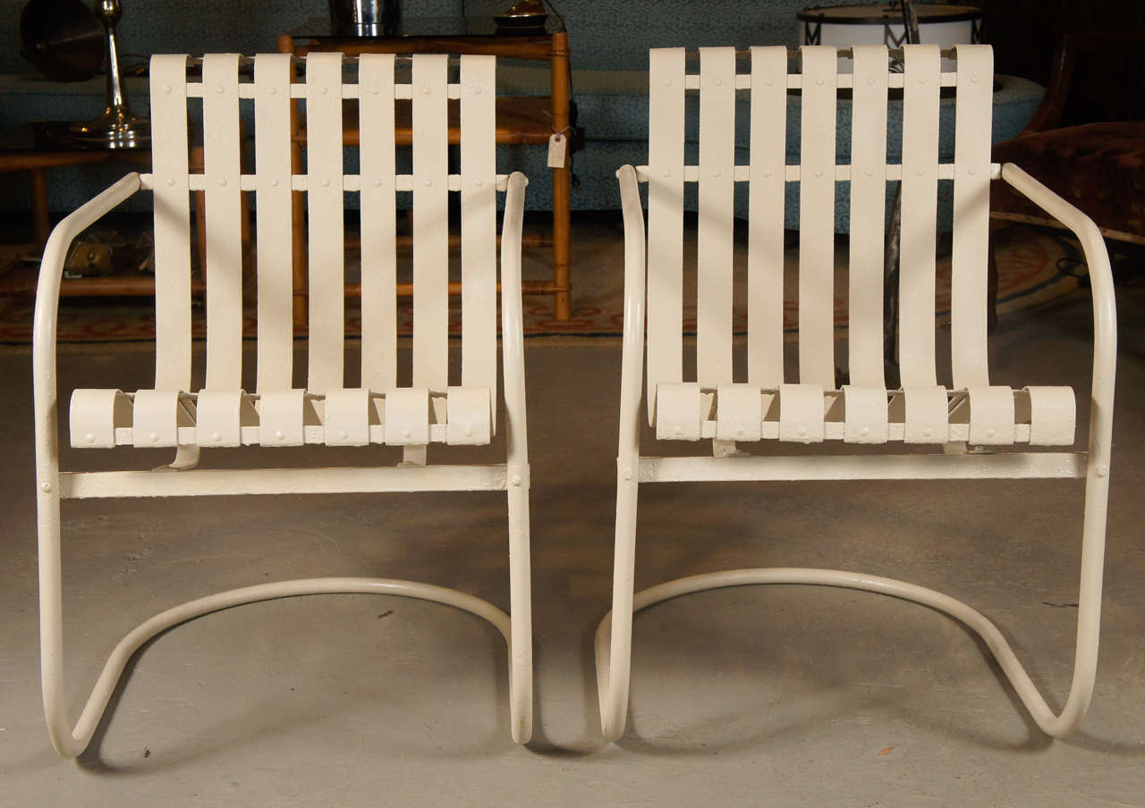 Fabulous rare pair of strap spring chairs from 1960. Form creates a generous deep seat that comforts the back in a supportive and unique way. 
Recently restored and bouncy to perfection.