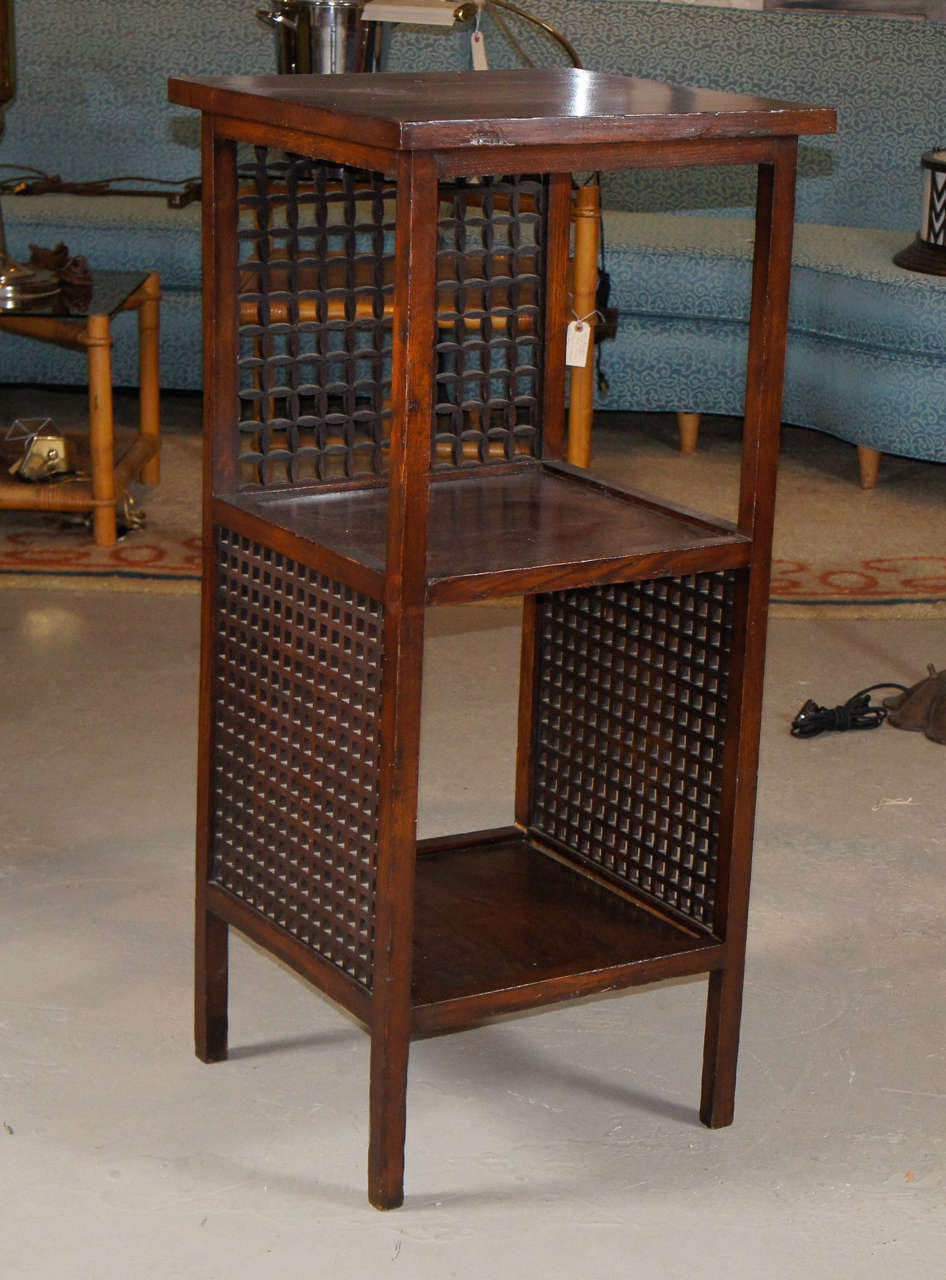 German two shelf stand in Mahogany with opposing style geometric grids sides. Fantastic form and function in the classic manor of the Wiener Workstatte. C. 1910