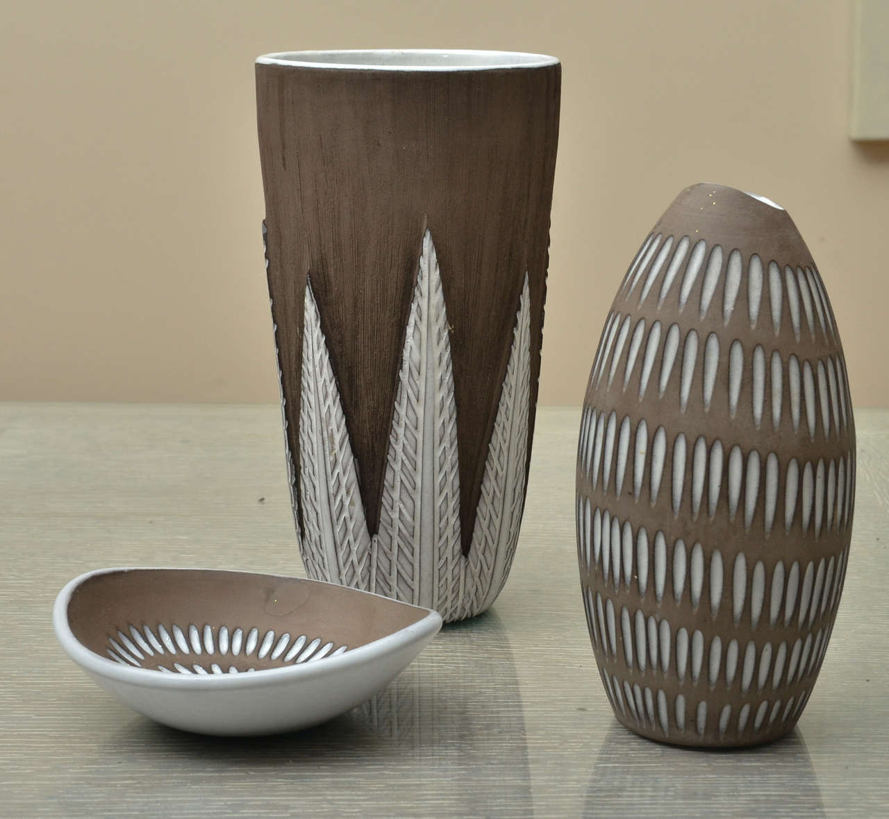 Group of 3 ceramics by Ekeby of Sweden.Bowl measurements are 5.25wide - 1.25 ht. Tall vase is 8.5 ht - 4.5 wide. Smaller vase is 7.25 ht - 3.5 wide. All signed