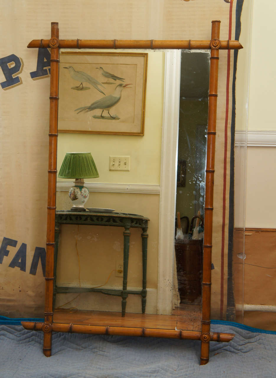 Victorian faux bamboo mirror.  Rectangular mirror plate within faux bamboo
borders with rondels at corners.