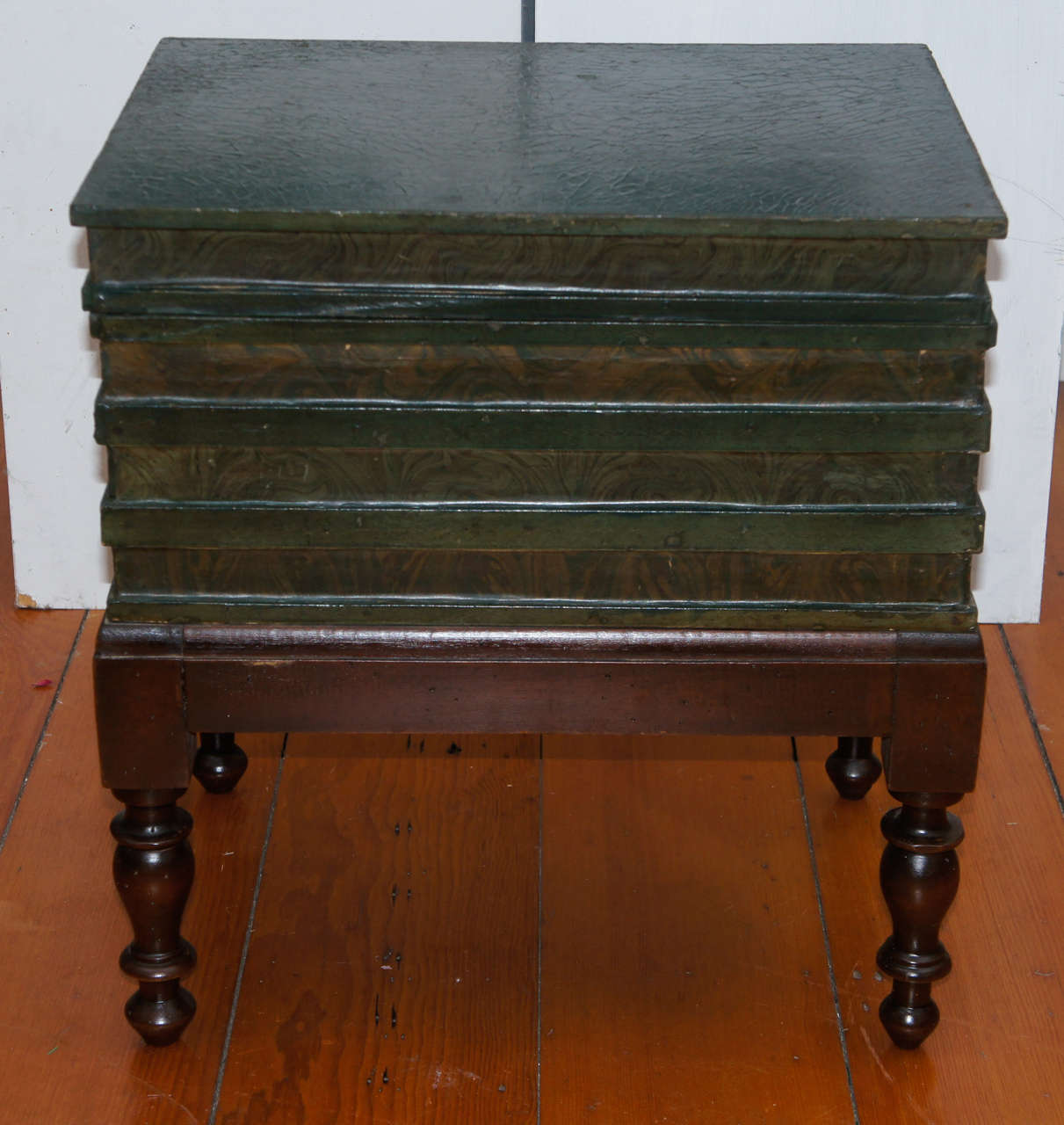 Victorian painted low table, bible box, in the form of a stack of four books. Raised on turned legs with a welled yellow painted interior, fitted with one
short drawer or interior storage compartment.