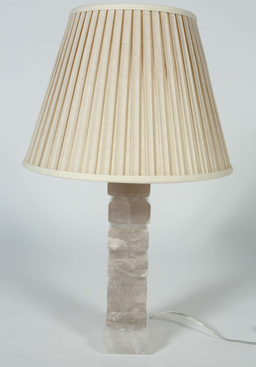 This gorgeous lamp is constructed of stacked rock crystal.  The lamps' modern form and neutral color palette allow it to work well in classic and contemporary spaces. 
This lamp would be terrific as a bedside table or on an end table in a living
