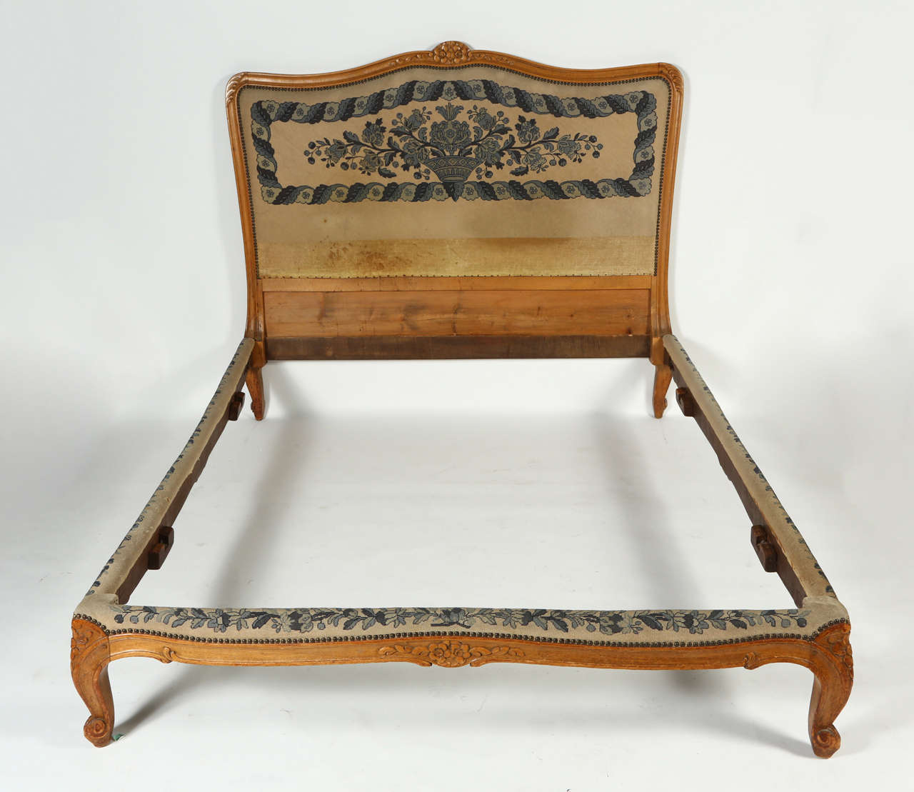 The headboard, side and foot end support of this 19th century French bed boasts lovely blue and white needlepoint. The oak frame is beautifully carved lending an elegance to any bedroom. Dates to circa 1880s.

Frame base measures 13