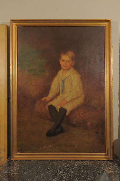 The full length portrait of an endearing young boy with light blue eyes and blonde hair, wearing a sailor suit with black stocking and leather shoes, seated on a log in a garden landscape. Signed in lower right ‘v. Krumhaar’ (Otto von Krumhaar