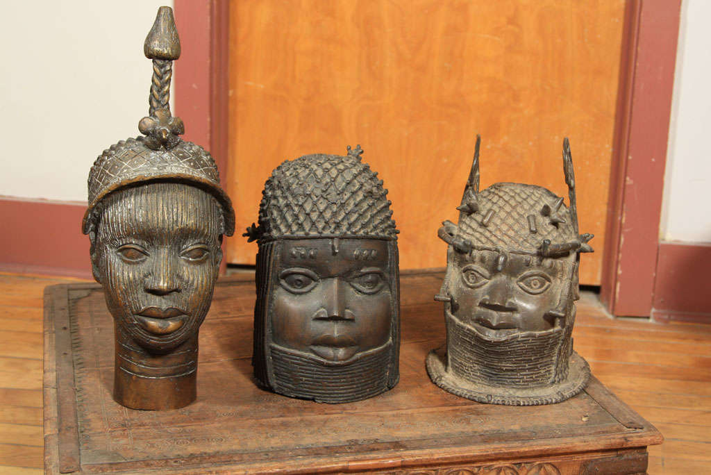 This  is a reproduction of the ancient bronze head in the collection of the
museum in Benin, Nigeria It is cast in the lost wax method.Only one still available is the shorter helmet on the right facing end.  That one is priced at 
$680.