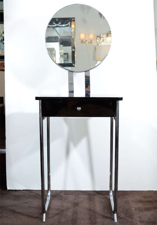 Art Deco Machine Age Streamlined vanity designed by Wolfgang Hoffmann. Features black lacquer with chromed fittings, circular mirror and single chromed pull.