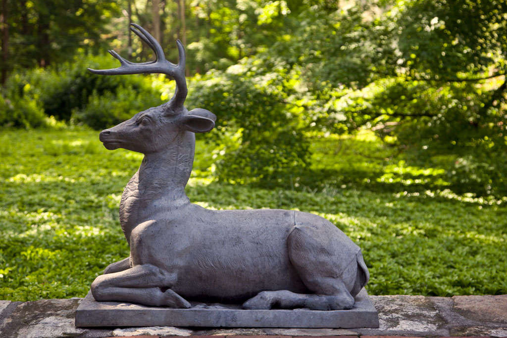 A recumbent zinc stag, with head held high and front hooves tucked under. This stag is termed the 