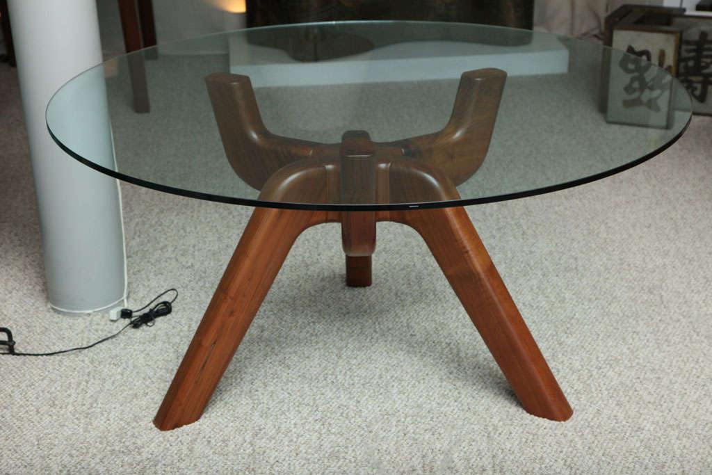 Gorgeous, sculptural dining or center table, of Italian Walnut with thick crystal top. This table is from a small edition produced by Delecta, and was only being offered for a short period of time.  Signed on wood base.