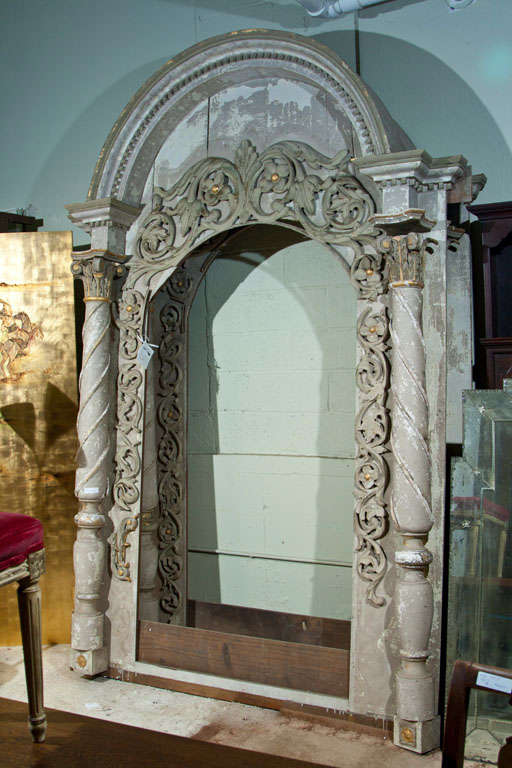 From the home of famed Hollywood actor Jack Palance. Pair of magnificent monumental architectural doorways or mirrors. Each column form flanked side carved and gilt in early 19th century decoration supporting a C-shaped arch also carved and gilt.