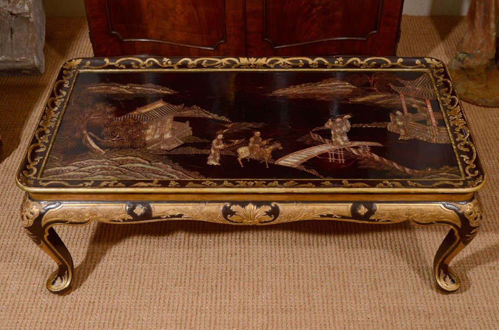 The black and gold painted base with inset 18th Chinese lacquer top depicting a pastoral scene of figures, pagodas, river and trees.