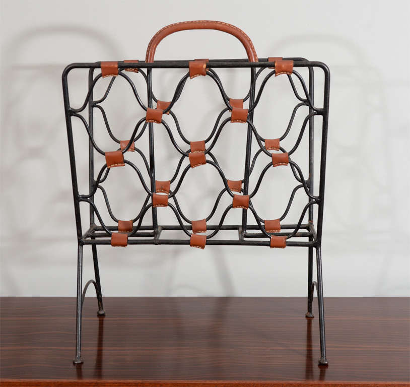 Leather and iron magazine holder by Jacques Adnet with top stitched leather accents. beautiful patina.