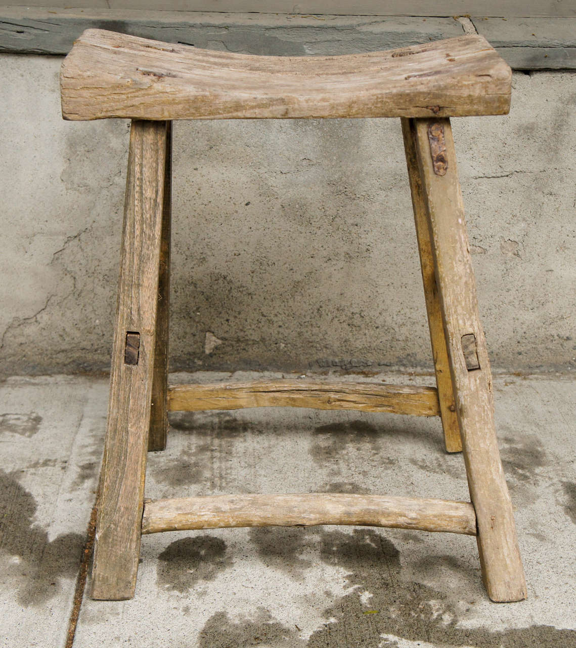 
This lovely and simple stool was made in the classical tradition of the Chinese craftsmen with dovetailed mortis and tenion joints and was created from elm, a venerated Chinese wood used through out that countries history. Made in the very late