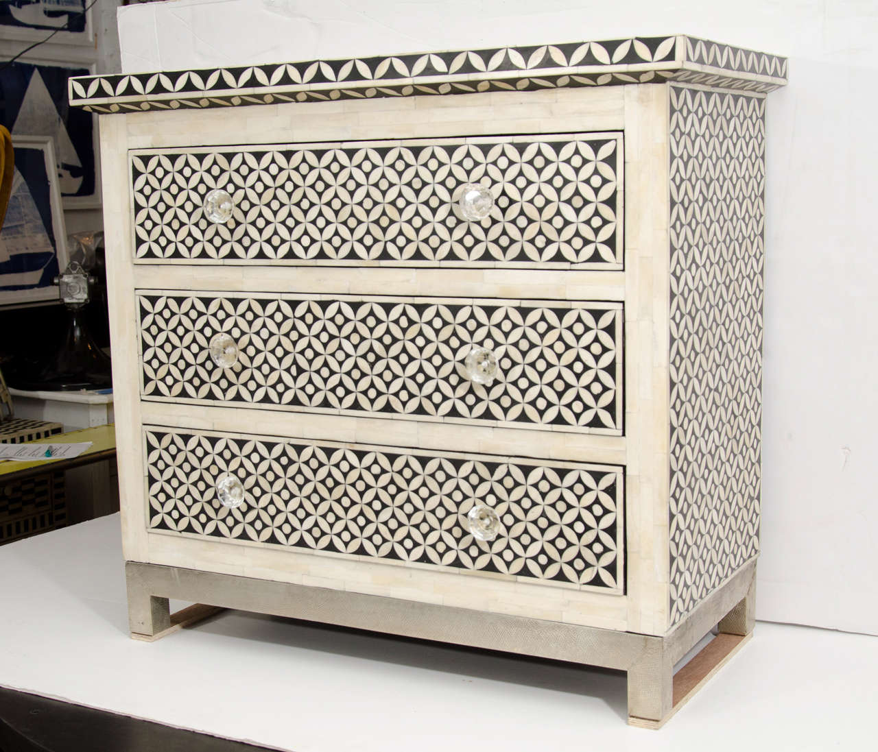 21st Century black and white geometric pattern.
White bone trim, 3 drawers, and square metal stand.