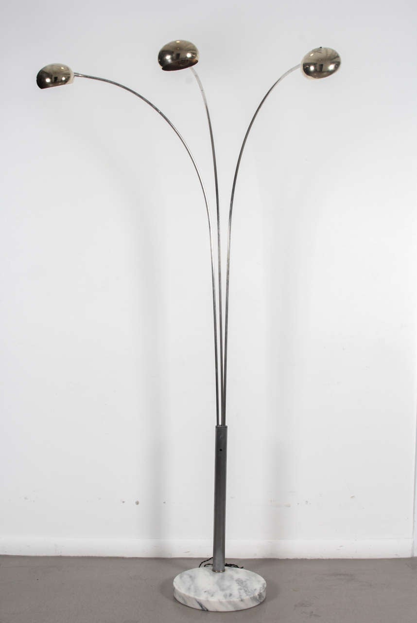 A 3-arm arc floor lamp.  Italian, circa 1960.

Features a thick round Carrara marble base with brushed metal stem and brass shades.  Rewired/restored; takes 3 standard U.S. bulbs (75 watts max.)

Dimensions:
79.5 inch height
31 inch width (arm