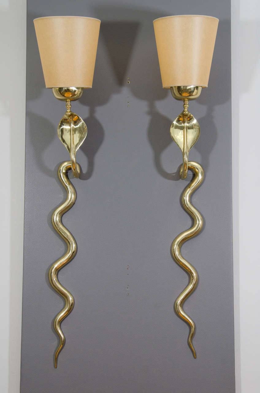 Cast bronze cobra sconces.