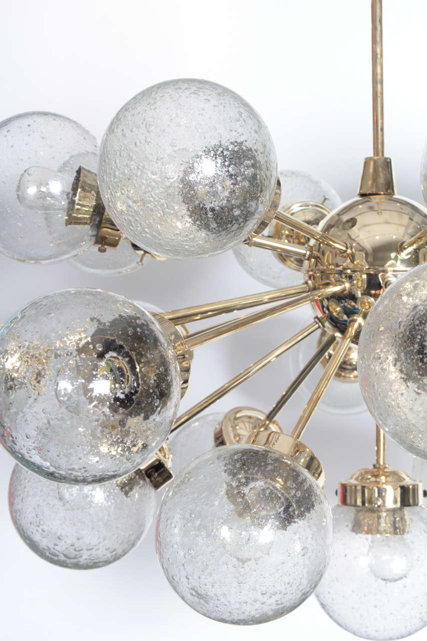 Amazing large scale brass sputnik chandelier with 25 glass globes by Doria. Stem can be cut to size. Chandelier body measures 21.5 inches tall.