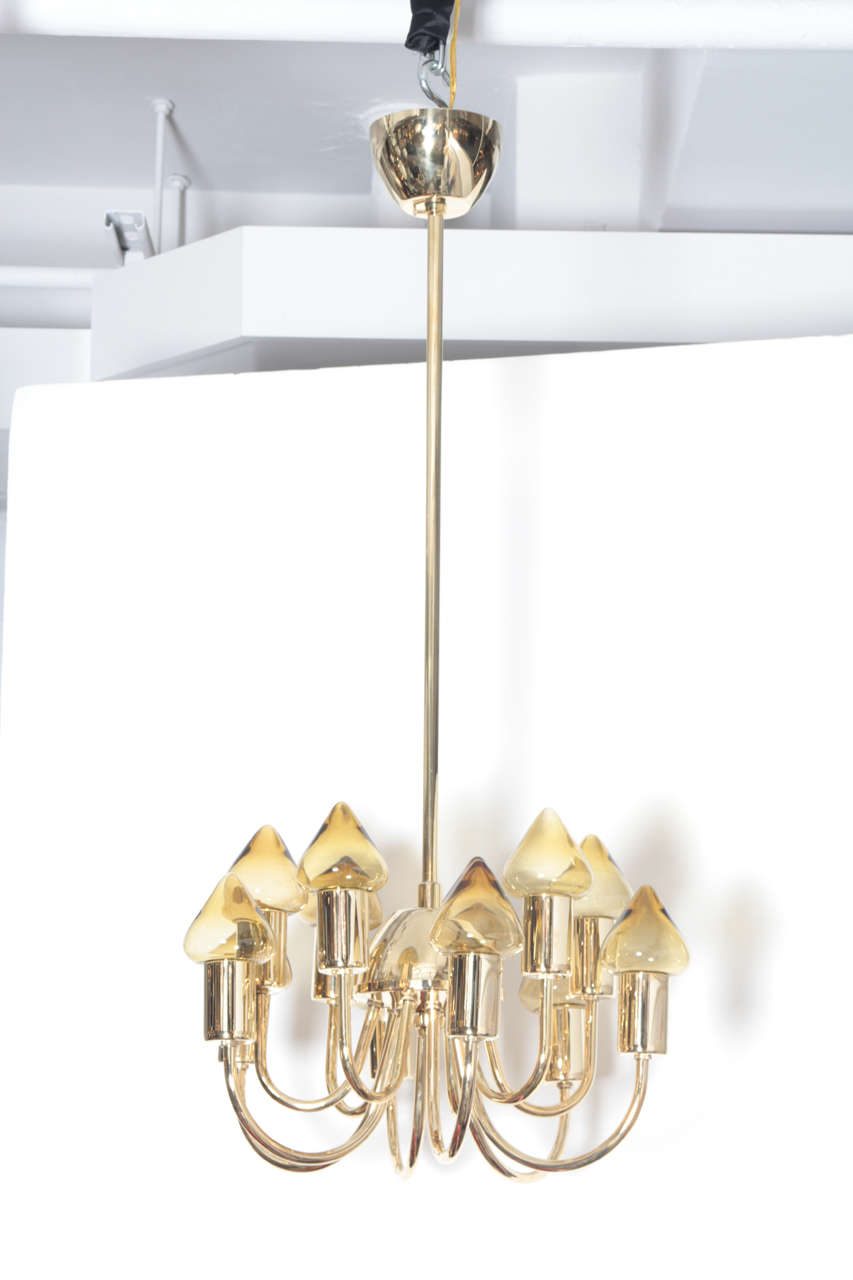 Fantastic twelve-arm brass chandelier with amber tinted glass dome shades by Hans Agne Jakobsson. Body of chandelier is 11