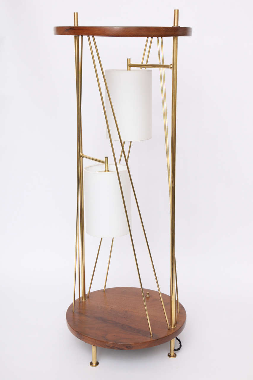 A 1950s architectural design table lamp, composed of round wood top and base, joined by polished brass, two lights at center.