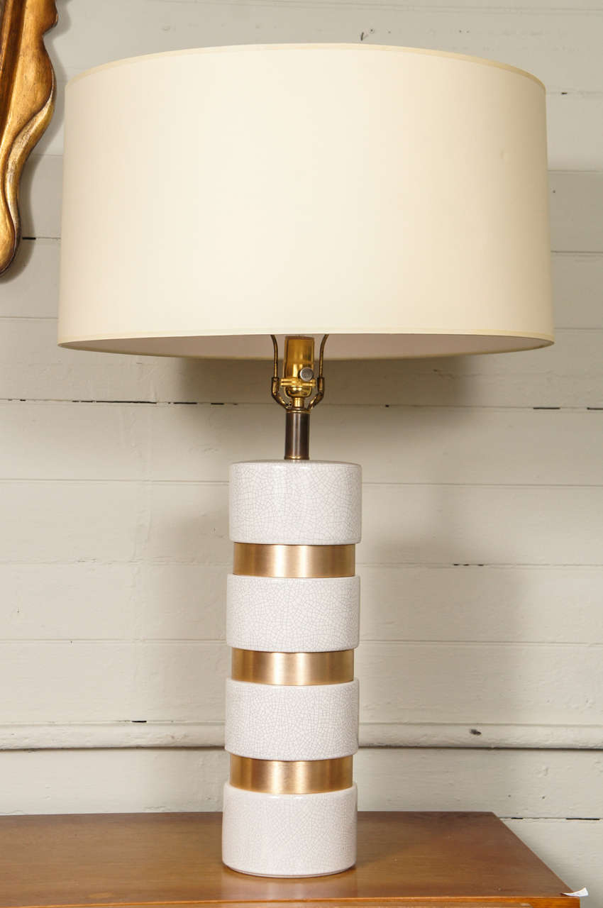 Single table lamp, composed of repeating Raku glazed pottery, and brushed bronzed metal bands. 