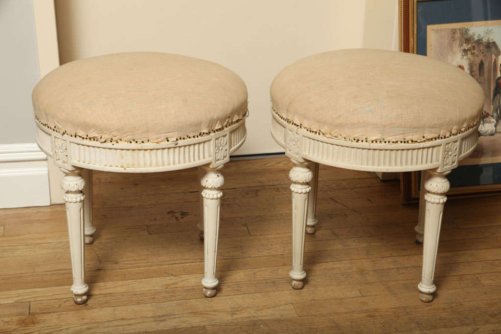 A Pair of Upholstered Round Swedish Ottomans