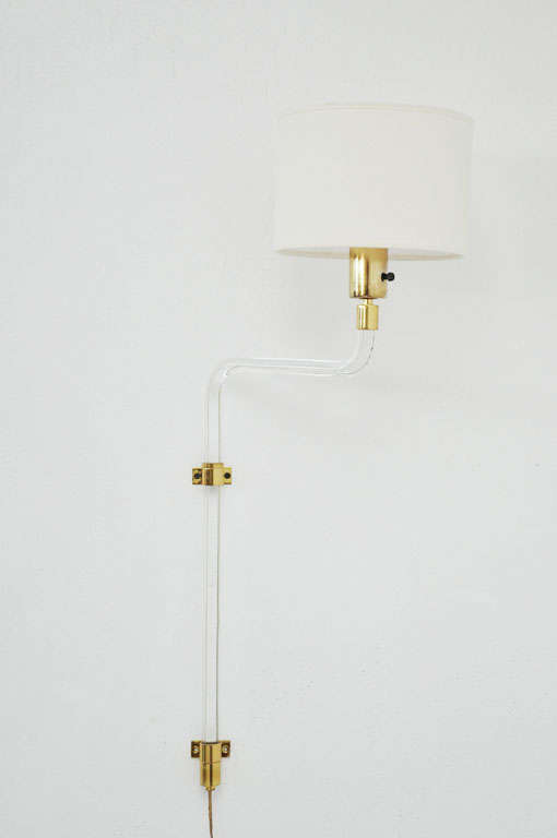 Pair of wall mount lamps by Peter Hamburger for Knoll. Lucite stems with brass hardware. Pivot from side to side, and height can be adjusted.