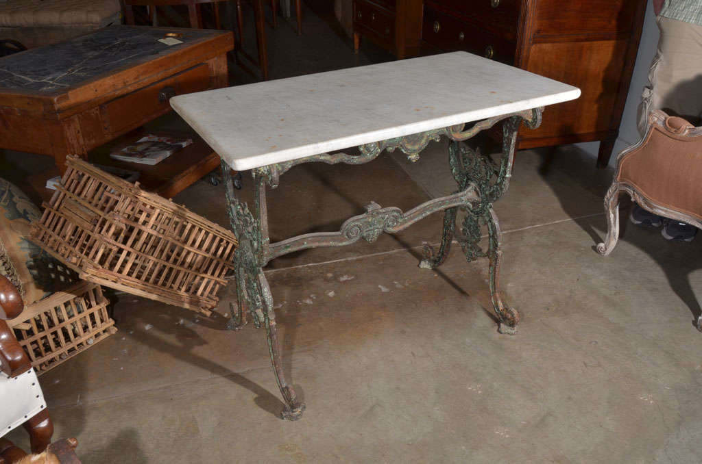 19th century French iron Patisserie table with intricate cast iron detail on legs and stretcher. Original marble-top.