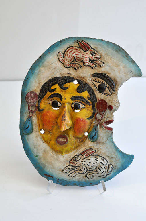Sculptural, painted metal folk art mask from Mexico-- possibly used in a ritual dance. Three-dimensional face with applied painted metal earrings